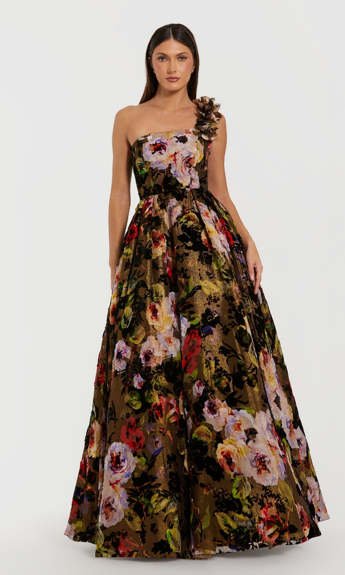 Woman wearing a strapless floral ball gown on a white background